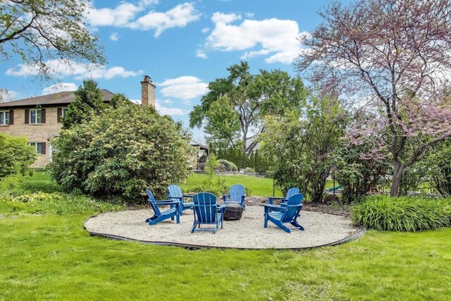 2481 Benton St, Palatine, IL 60067 - view of green lawn with a patio area and an outdoor fire pit