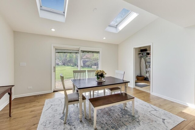 2481 Benton St, Palatine, IL 60067 - dining area with a skylight, light wood-style flooring, vaulted ceiling, baseboards, and recessed lighting