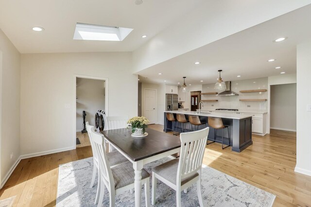 2481 Benton St, Palatine, IL 60067 - dining area featuring a skylight, light wood-style flooring, baseboards, lofted ceiling, and recessed lighting