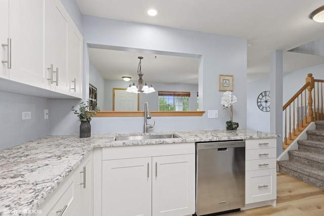 39674 N Warren Ln Unit 0, Beach Park, IL 60083 - kitchen with stainless steel dishwasher, a sink, light wood-type flooring, white cabinets, and a chandelier