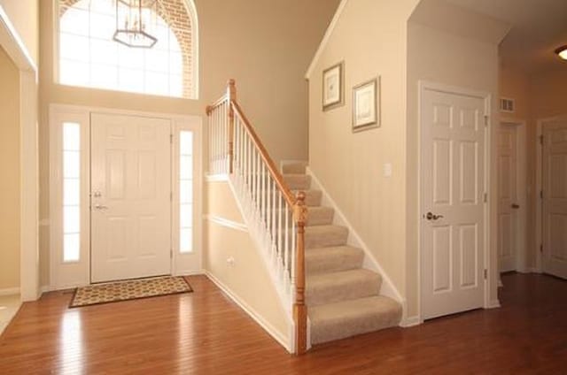 254 S Cranberry St, Bolingbrook, IL 60490 - foyer with wood finished floors, stairs, baseboards, and a chandelier