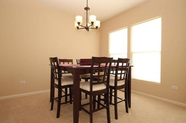 254 S Cranberry St, Bolingbrook, IL 60490 - dining area with a chandelier, light carpet, and baseboards