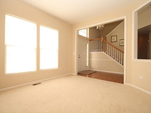 254 S Cranberry St, Bolingbrook, IL 60490 - carpeted entryway with a chandelier, stairs, and baseboards