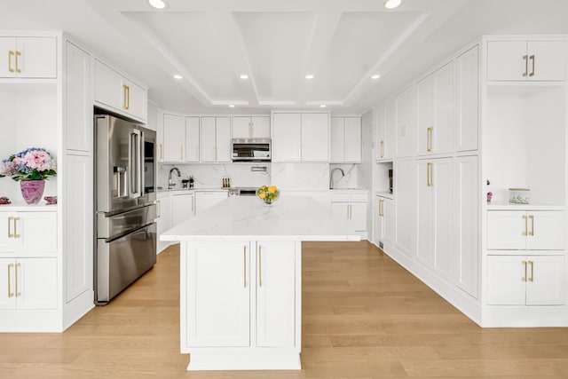 405 N Wabash Ave Unit 4308, Chicago, IL 60611 - kitchen with stainless steel appliances, a center island, white cabinetry, recessed lighting, and light wood-style floors
