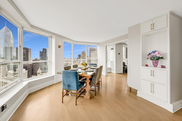 405 N Wabash Ave Unit 4308, Chicago, IL 60611 - dining area with a view of skyline, light wood-type flooring, and baseboards