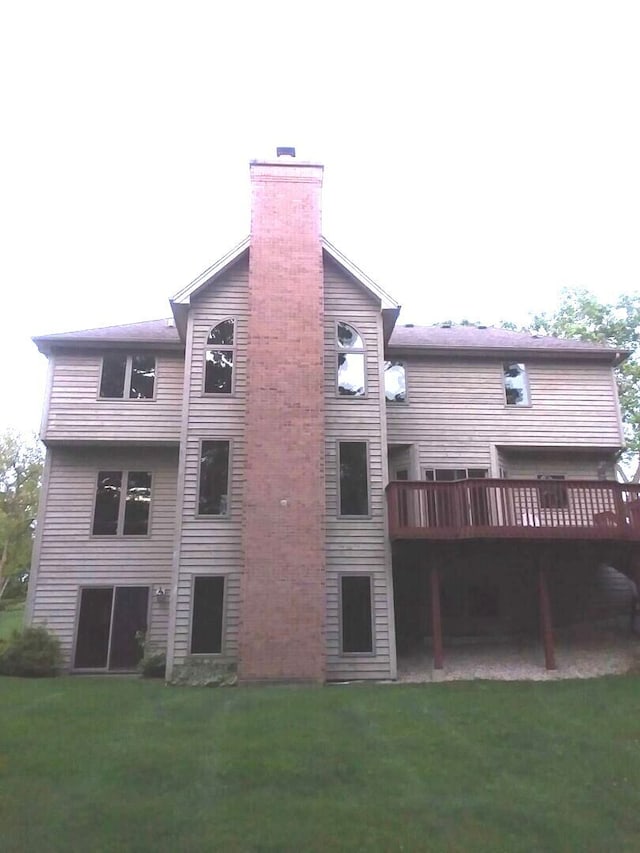 4301 Hickory Hill Ct, Johnsburg, IL 60051 - rear view of property with a chimney, a wooden deck, and a yard