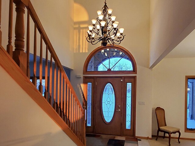 4301 Hickory Hill Ct, Johnsburg, IL 60051 - entrance foyer featuring a towering ceiling, a chandelier, stairs, and baseboards