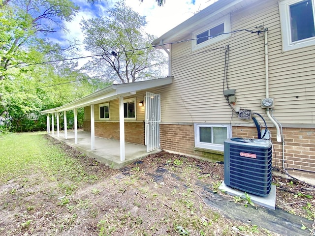 332 Gentry St, Park Forest, IL 60466 - view of side of property with central air condition unit and a patio area