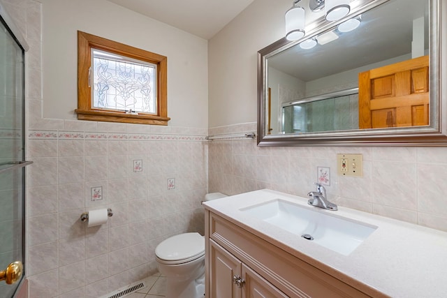 6856 W Montrose Ave, Harwood Heights, IL 60706 - bathroom with vanity, tile patterned flooring, an enclosed shower, tile walls, and wainscoting