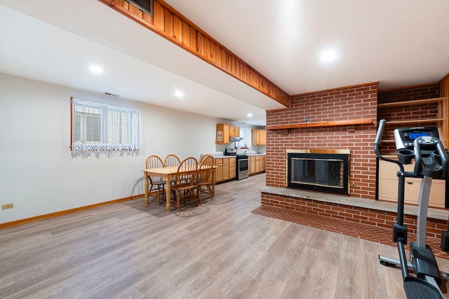 6856 W Montrose Ave, Harwood Heights, IL 60706 - workout area featuring light wood-style floors, a brick fireplace, and recessed lighting