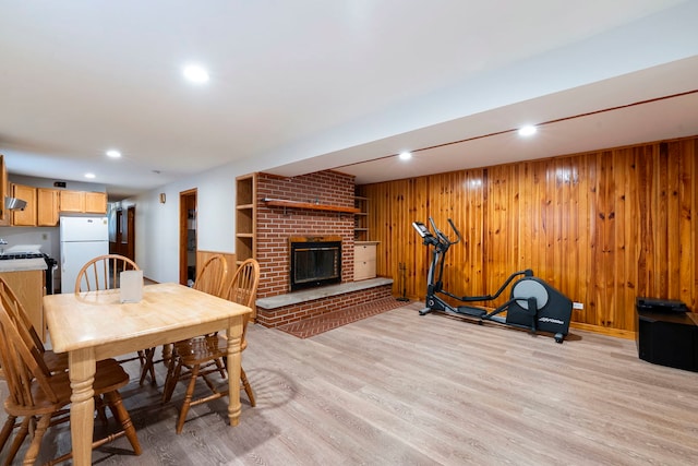 6856 W Montrose Ave, Harwood Heights, IL 60706 - dining room with light wood-type flooring, wood walls, a fireplace, and recessed lighting