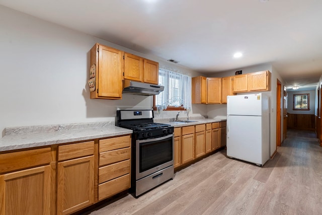 6856 W Montrose Ave, Harwood Heights, IL 60706 - kitchen featuring stainless steel range with gas cooktop, freestanding refrigerator, under cabinet range hood, and light countertops