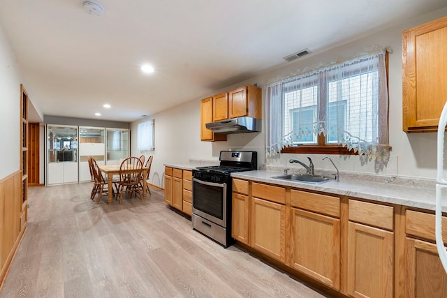 6856 W Montrose Ave, Harwood Heights, IL 60706 - kitchen with stainless steel gas range, under cabinet range hood, light wood-style floors, light countertops, and recessed lighting