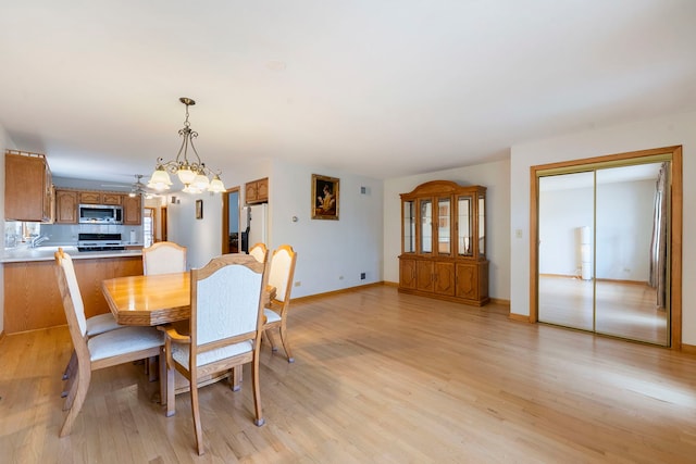 6856 W Montrose Ave, Harwood Heights, IL 60706 - dining room featuring a chandelier and light wood finished floors