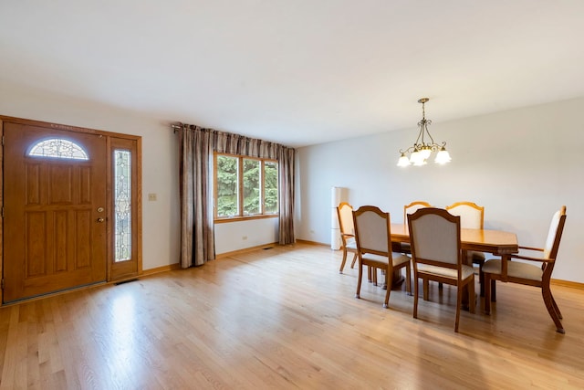 6856 W Montrose Ave, Harwood Heights, IL 60706 - dining room with light wood-style floors and a chandelier