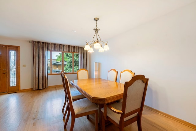 6856 W Montrose Ave, Harwood Heights, IL 60706 - dining space featuring a chandelier and light wood finished floors