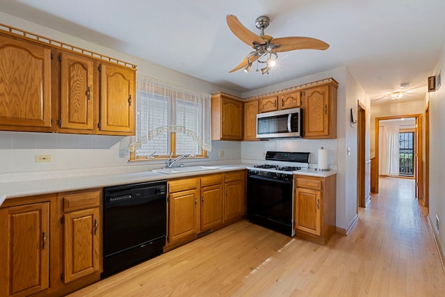 6856 W Montrose Ave, Harwood Heights, IL 60706 - kitchen with dishwasher, gas range oven, stainless steel microwave, brown cabinetry, and light wood-style flooring