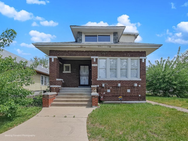 12155 S Normal Ave, Chicago, IL 60628 - bungalow with brick siding, a front lawn, and a porch