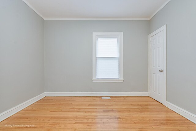12155 S Normal Ave, Chicago, IL 60628 - empty room with crown molding, wood finished floors, healthy amount of natural light, and baseboards