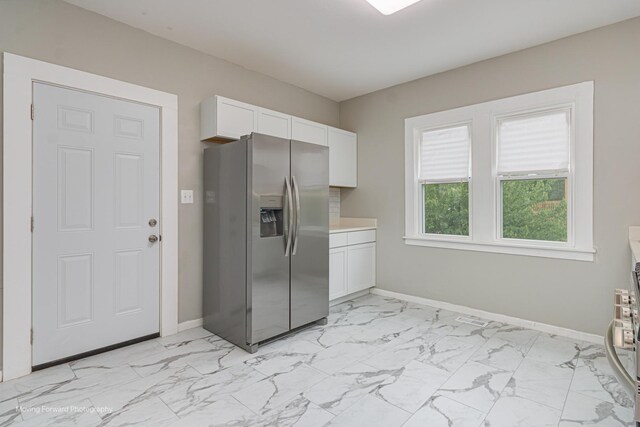 12155 S Normal Ave, Chicago, IL 60628 - kitchen featuring stainless steel fridge with ice dispenser, light marble finish floors, white cabinetry, and baseboards