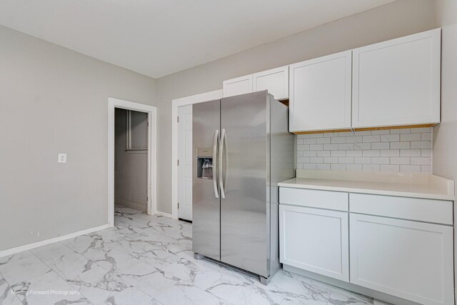12155 S Normal Ave, Chicago, IL 60628 - kitchen featuring stainless steel fridge with ice dispenser, light marble finish floors, light countertops, baseboards, and white cabinets