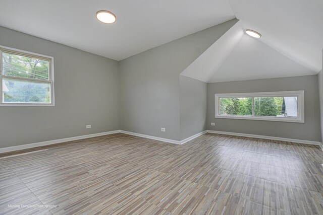 12155 S Normal Ave, Chicago, IL 60628 - empty room featuring light wood-style floors, baseboards, and lofted ceiling