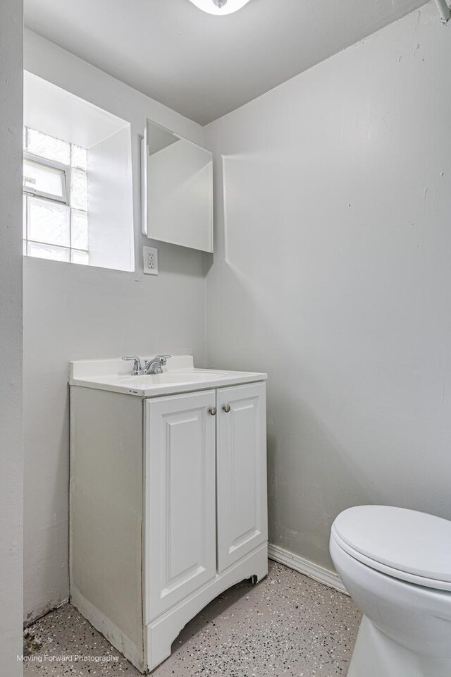 12155 S Normal Ave, Chicago, IL 60628 - bathroom featuring vanity, toilet, and baseboards