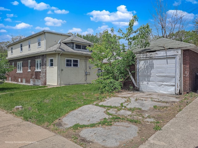 12155 S Normal Ave, Chicago, IL 60628 - view of side of home with a lawn, an outbuilding, a garage, driveway, and brick siding