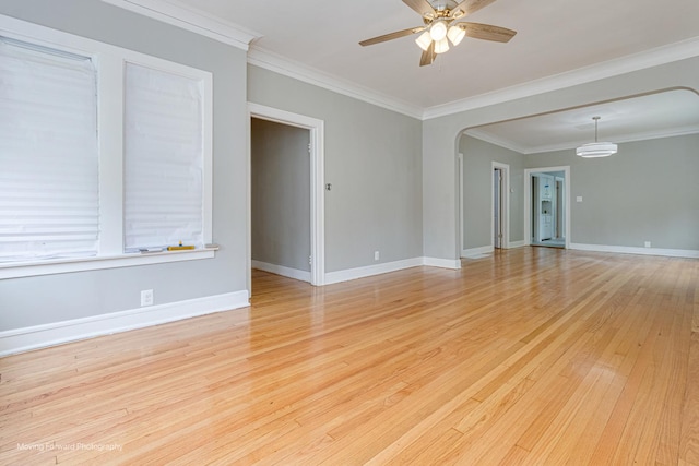 12155 S Normal Ave, Chicago, IL 60628 - unfurnished room with ceiling fan, light wood-style flooring, crown molding, arched walkways, and baseboards