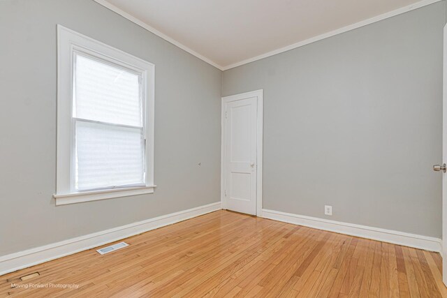 12155 S Normal Ave, Chicago, IL 60628 - empty room featuring crown molding, light wood-style floors, and baseboards