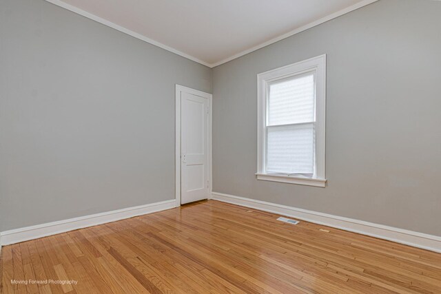 12155 S Normal Ave, Chicago, IL 60628 - empty room with crown molding, baseboards, and light wood-type flooring