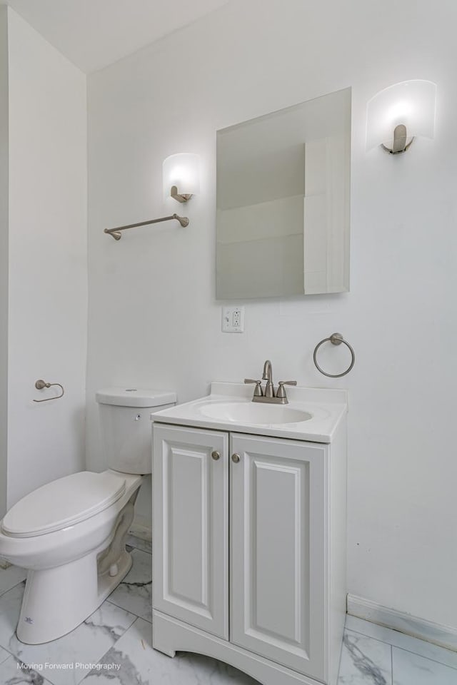12155 S Normal Ave, Chicago, IL 60628 - bathroom featuring marble finish floors, toilet, vanity, and baseboards