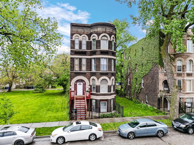 9035 S Burley Ave, Chicago, IL 60617 - view of front facade featuring brick siding, a front lawn, and stone siding