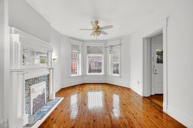 9035 S Burley Ave, Chicago, IL 60617 - unfurnished living room featuring a ceiling fan, hardwood / wood-style floors, and a tile fireplace