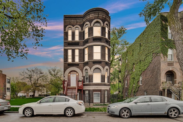 9035 S Burley Ave, Chicago, IL 60617 - view of property featuring brick siding, stone siding, and stairway