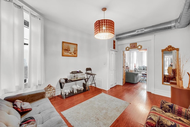 9035 S Burley Ave, Chicago, IL 60617 - living room featuring healthy amount of natural light, wood finished floors, and a chandelier
