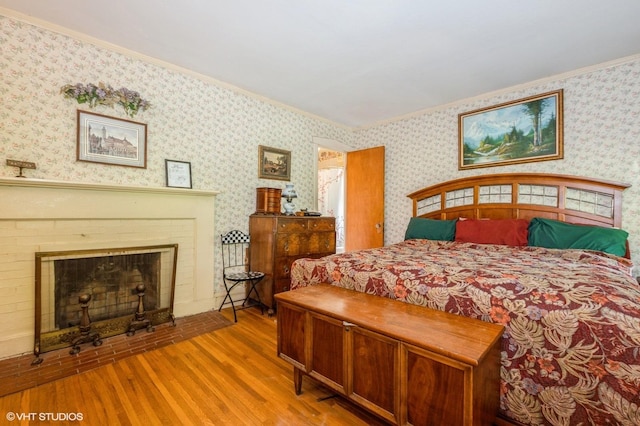 10716 S Hoyne Ave, Chicago, IL 60643 - bedroom featuring wood finished floors, crown molding, wallpapered walls, and a fireplace