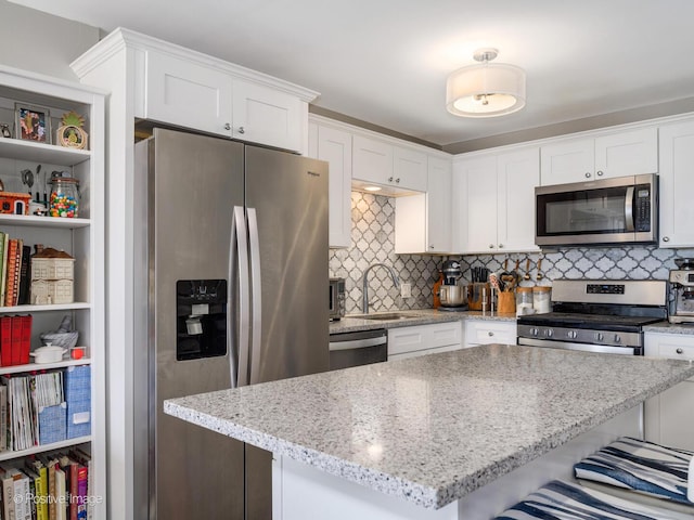 1960 N Lincoln Park W Unit 1008, Chicago, IL 60614 - kitchen featuring stainless steel appliances, a sink, white cabinets, and tasteful backsplash