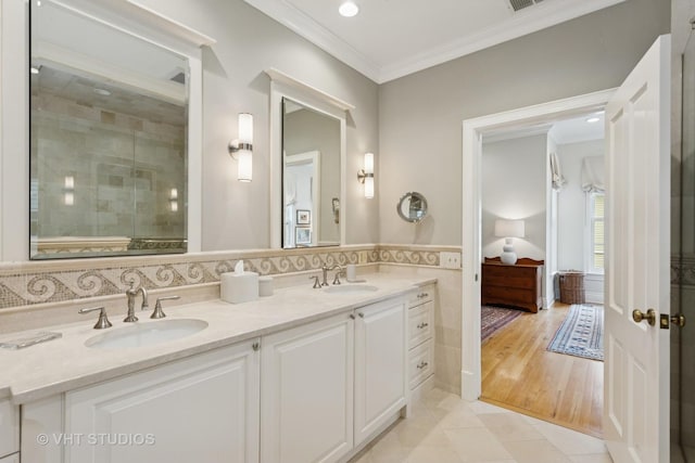 1224 Hinman Ave, Evanston, IL 60202 - ensuite bathroom featuring ornamental molding, double vanity, tile patterned flooring, and tiled shower