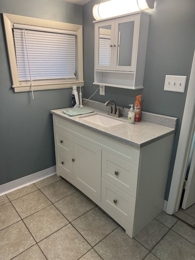 bathroom featuring tile patterned floors, vanity, and baseboards