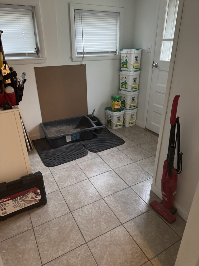 bathroom featuring tile patterned floors, healthy amount of natural light, and baseboards