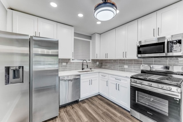 328 Nassau St, Park Forest, IL 60466 - kitchen featuring appliances with stainless steel finishes, a sink, recessed lighting, white cabinets, and tasteful backsplash