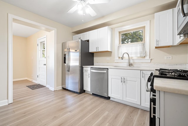 5701 N Mobile Ave, Chicago, IL 60646 - kitchen featuring appliances with stainless steel finishes, a sink, a ceiling fan, light countertops, and light wood-style flooring