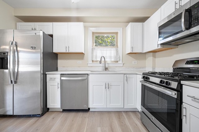5701 N Mobile Ave, Chicago, IL 60646 - kitchen featuring stainless steel appliances, a sink, white cabinetry, and light countertops