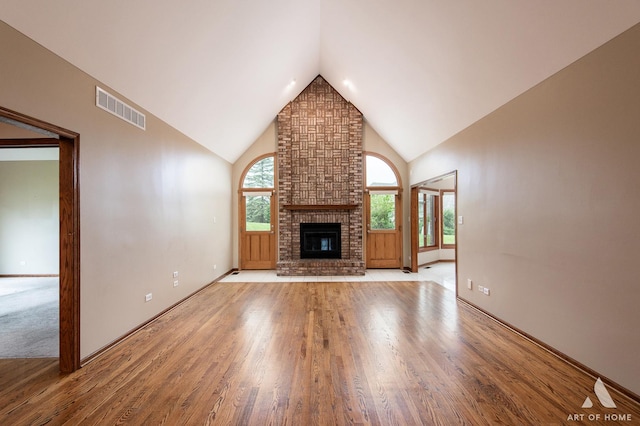 10801 Jillian Rd, Orland Park, IL 60467 - unfurnished living room with light wood-type flooring, a fireplace, high vaulted ceiling, and baseboards