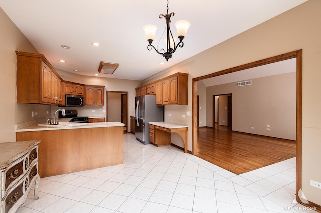 10801 Jillian Rd, Orland Park, IL 60467 - kitchen with appliances with stainless steel finishes, a sink, light countertops, light tile patterned flooring, and a chandelier
