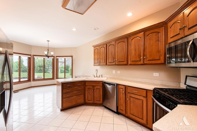 10801 Jillian Rd, Orland Park, IL 60467 - kitchen featuring stainless steel appliances, a sink, a peninsula, a chandelier, and light countertops