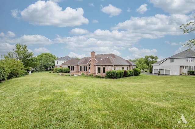 10801 Jillian Rd, Orland Park, IL 60467 - back of house with a yard, a chimney, brick siding, and a garage