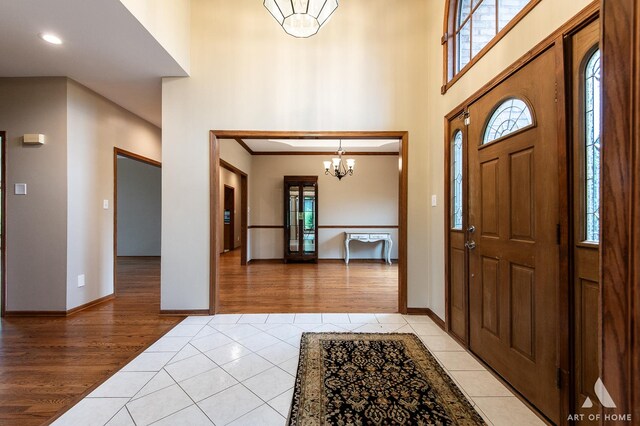10801 Jillian Rd, Orland Park, IL 60467 - entryway with light tile patterned flooring, inlaid floor details, healthy amount of natural light, recessed lighting, and a high ceiling