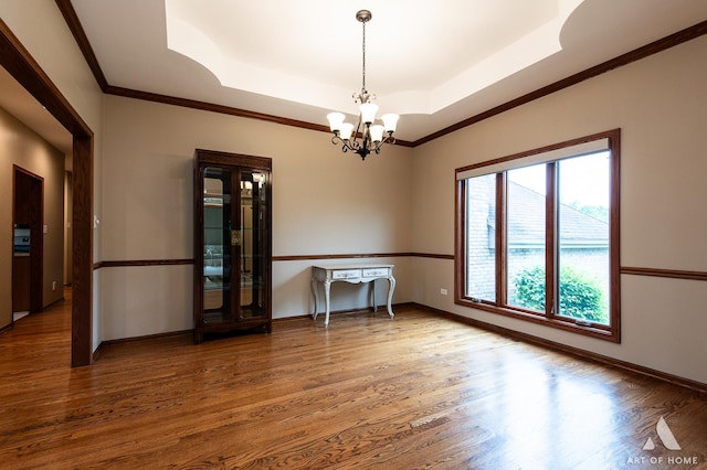 10801 Jillian Rd, Orland Park, IL 60467 - unfurnished room with a raised ceiling, a chandelier, wood finished floors, baseboards, and crown molding